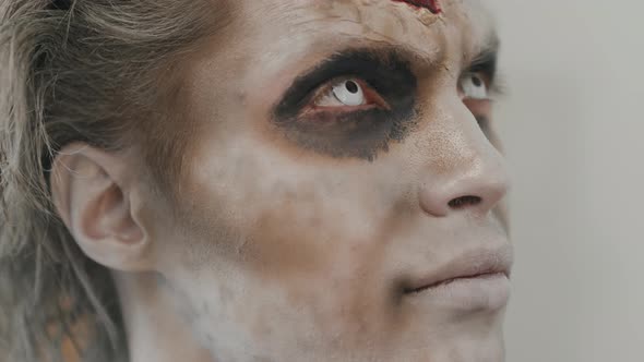 Unrecognizable Artist Doing SFX Makeup on Man