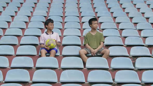 Kids Sitting At The Stadium And Watching Match