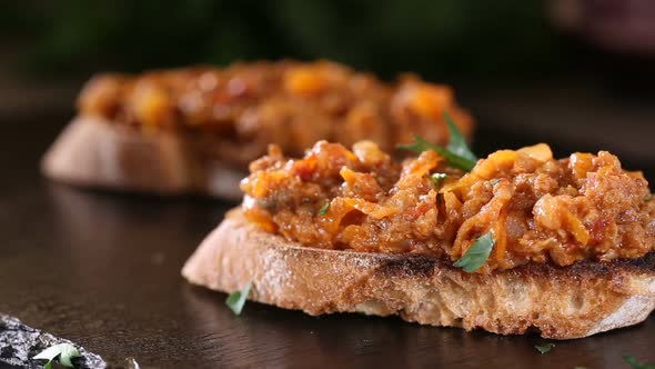 Spreading chopped parsley over Zacusca - Romanian vegetable spread