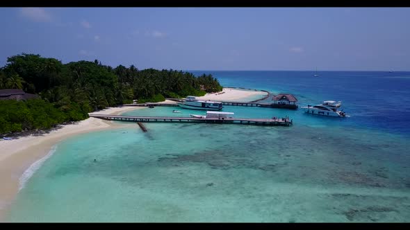 Aerial top down travel of idyllic shore beach trip by blue ocean with white sand background of a day