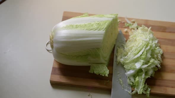 Sliced Chinese Cabbage and A Large Knife on A Cutting Board