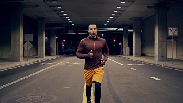 Athletic Male Running Through A Tunnel