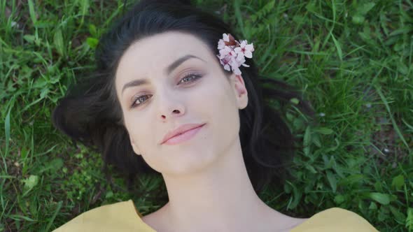 Girl lying on the grass and smiling