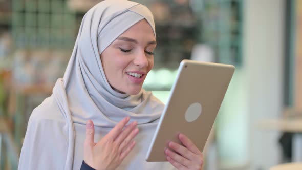 Portrait of Young Arab Woman Doing Video Call on Tablet 