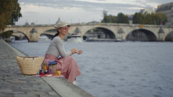 Young girl by the Seine in Paris