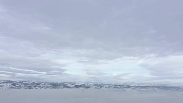 Clouds above smog from city heating systems 4K drone video