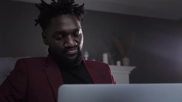 a Black Man Works at a Laptop Closeup of His Face