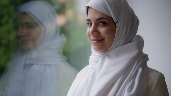 Young Beautiful Middle Eastern Woman with Charming Smile Turning to Camera Smiling