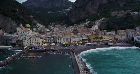 Amalfi below dramatic cliffs on the scenic Amalfi coast, Italy; aerial arc