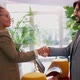 Smiling businesswoman and businessman shaking hands, Milan, Italy - VideoHive Item for Sale