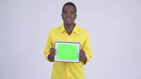 Young Happy African Businessman Showing Digital Tablet