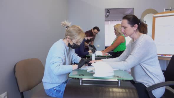 Two Manicure Masters in Black Masks are Taking Part in Retraining Courses