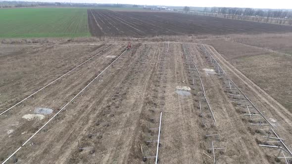 Drone View of the Field with a Construction of a Solar Power Station Going on