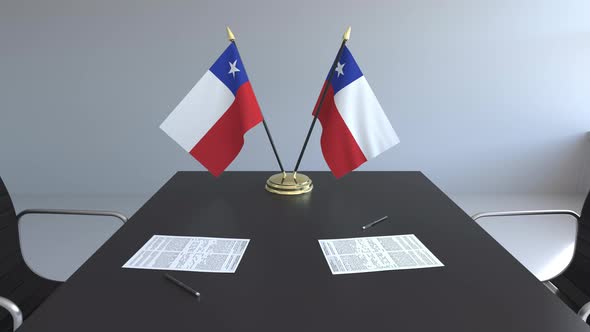 Flags of Chile and Papers on the Table alt