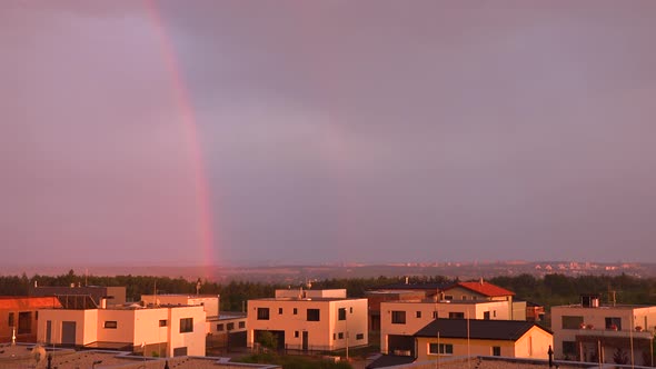 Suburban Cityscape with a Rainbow During Sunset