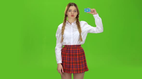 Schoolgirl Picks Up the Card and Points at It. Green Screen