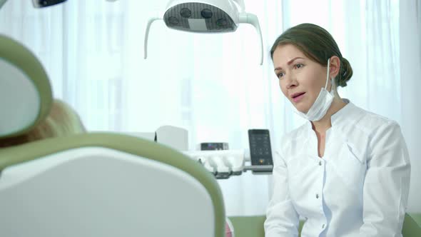 Doctor Talks About Something with Little Girl in Clinic.