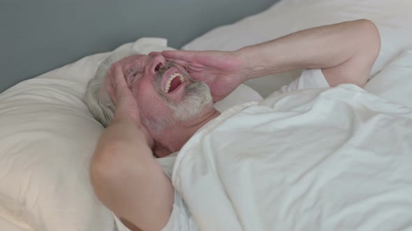 Old Man with Headache in Bed 