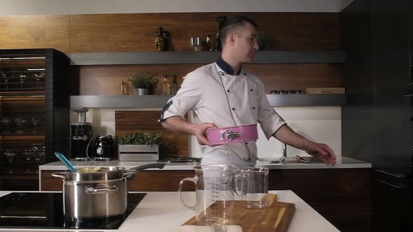 professional cook carries the dishes with the dough and puts them in the oven