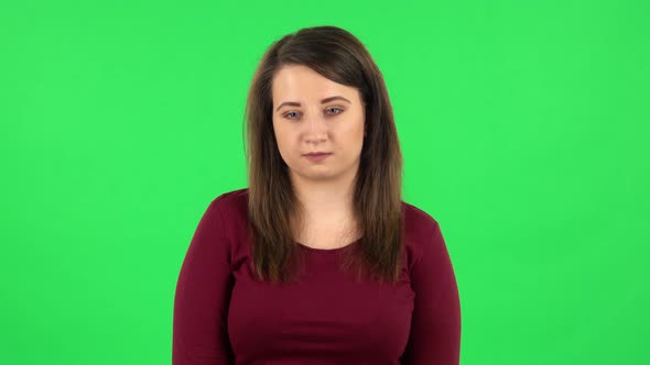 Portrait of Pretty Girl Worrying in Expectation Then Guilty Hides Her Eyes, Green Screen