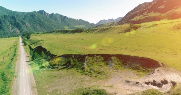 Aerial Rural Mountain Road and Meadow at Sunny Summer Morning