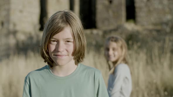 Front View of Smiling Boy Standing and Looking at Camera