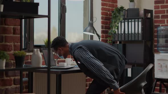 Business Man with Face Mask Sitting at Desk to Do e Commerce Task