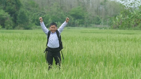 Asian Boy Cheering In Rice Field