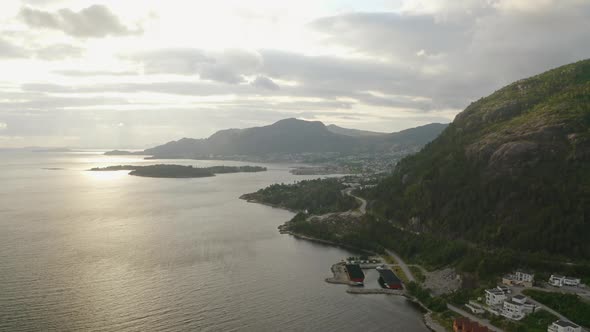 Drone Over Sunlit River And Mountains