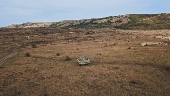 Military Army Tank Shooting Aerial View. Back View Armoured Combat Fighting Vechicle Shooting in