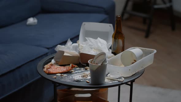 Close Up of Leftover Food on Table in Empty Messy Living Room