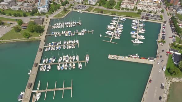 aerial overview of colourful harbour stocked with boats 4k