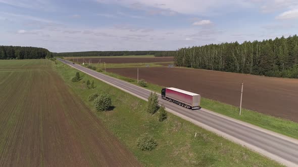 Aerial view of truck driving on a straight asphalt road 05 alt