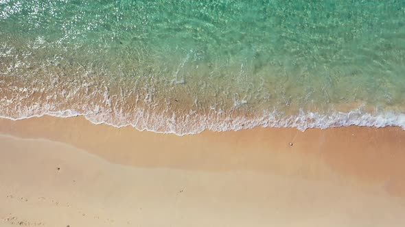 Natural birds eye island view of a sandy white paradise beach and aqua blue ocean background in colo