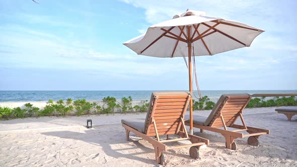 Beautiful tropical sea beach around with umbrella chair on blue sky