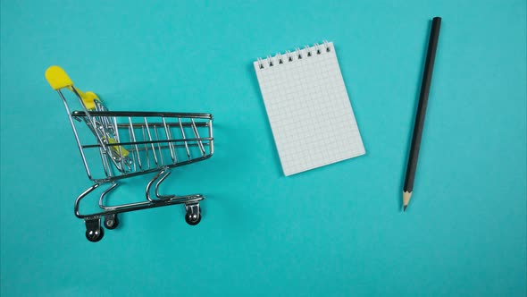 Blank Shopping List With Pencil Falls Into Cart. Stop Motion Animation