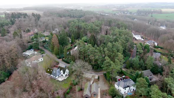 Aerial View of Big Villas with Garden Surrounded By Forest During Winter Season