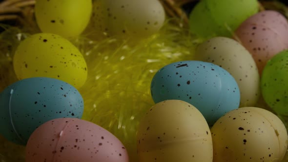 Rotating shot of Easter decorations and candy in colorful Easter grass