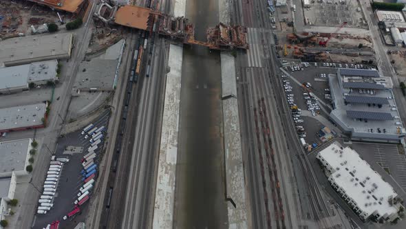 AERIAL: Overhead , Birds Eye View on Los Angeles River with Water on Cloudy Overcast Sky Next To