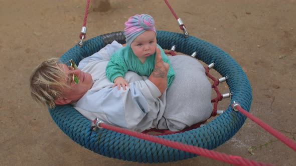 Disabled happy mother with baby, lifestyle outdoors.