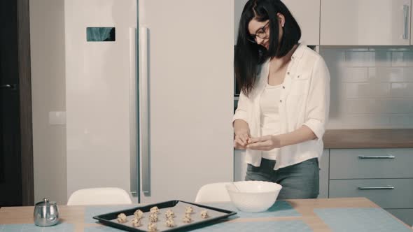 Young Woman Making Homemade Cookies in Kitchen