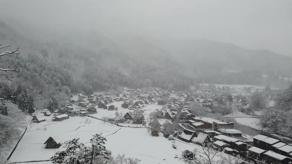 Snowfall In Village At Mountain