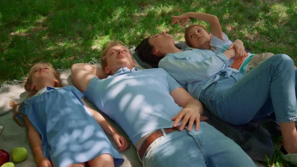 Happy Family Relax Lying on Picnic Blanket Close Up