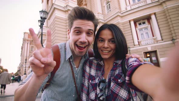 POV of the Young Mixed Race Tourist Couple Taking Selfie in Old City Center and Having Some Fun