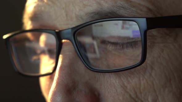 Closeup of the Focused Eyes of a Businessman Wearing Computer Glasses