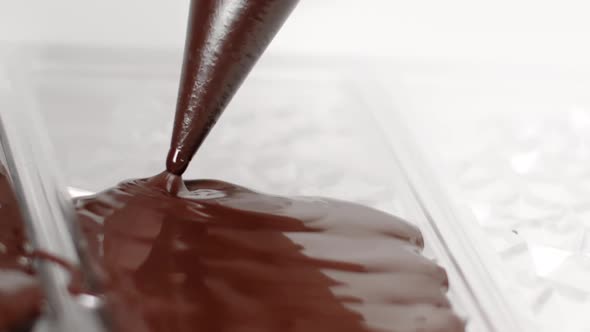 Chocolatier Pouring Melted Chocolate Into Mold Preparing Chocolate Bar Slow Mo