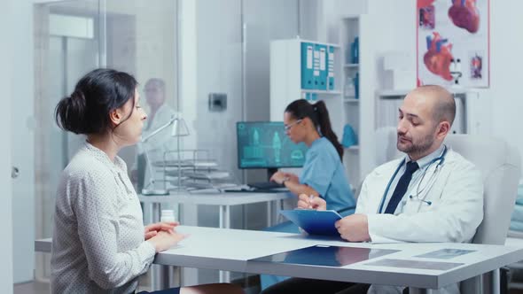 Doctor Questioning Young Female Patient