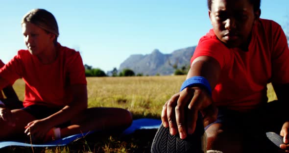 Trainer instructing kids while exercising in the boot camp