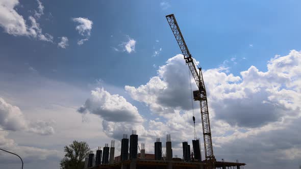 Tower Cranes and Professional Workers at High Concrete Residential Building Under Construction