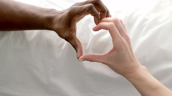 Heart From Hands Close Up Multiracial Couple African Man and Caucasian Woman Lovers Concept Mixed